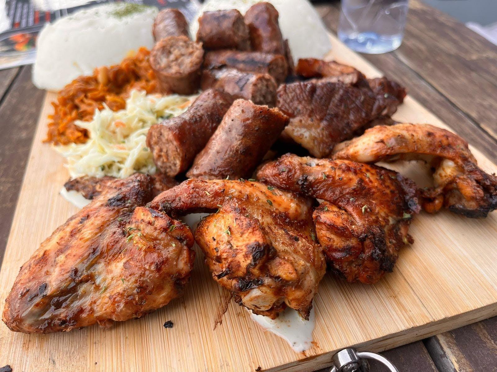 Chicken Bar flame-grilled chicken, wors, and steak platter with pap and coleslaw